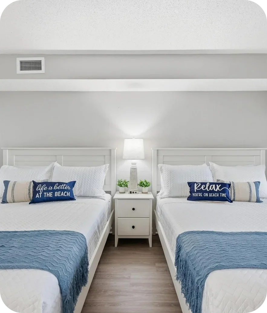 Interior painting services in Myrtle Beach SC — freshly painted hotel bedroom with coastal blue and white decor by Apex Painting